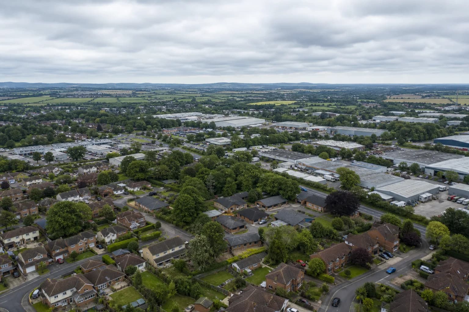 Aerial view over Hampshire rooftops and countryside